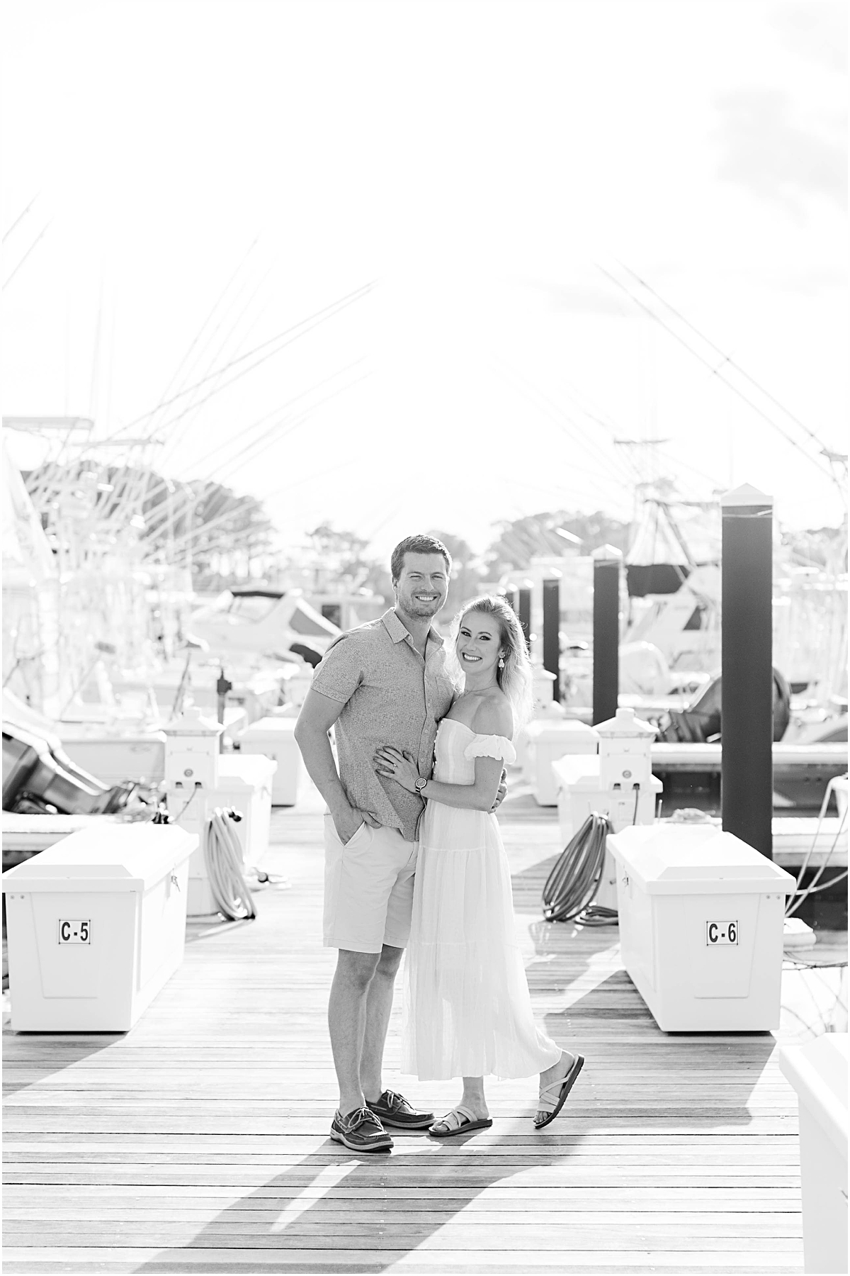 Black and white photo of Val and Don standing chest to chest on the pier at Bethany Beach.