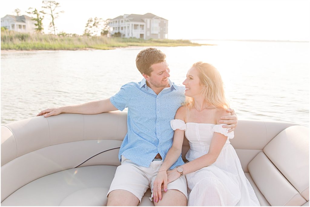 Don and Val sitting on the seat of a boat at Bethany Beach during their engagement session.