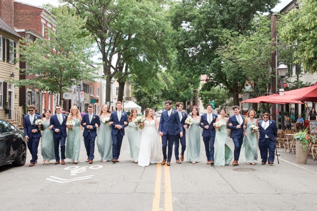 Jessica and Seamus walking through Alexandria Virginia with their wedding party, wedding photography done by Ashley.  