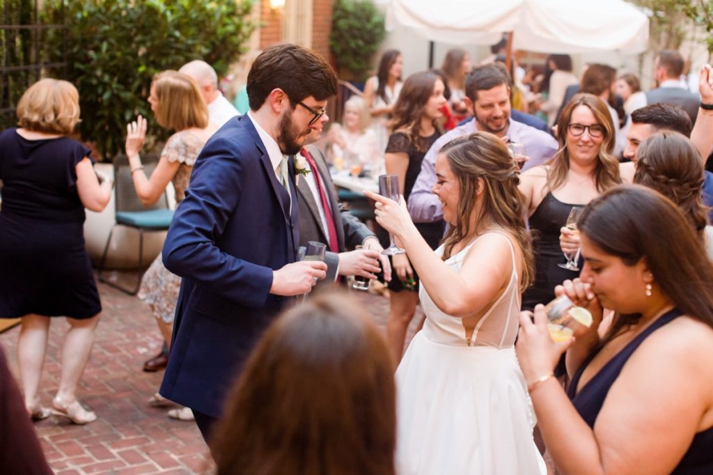 Jessica and Seamus dancing and drinking during the party, wedding photography done in Alexandria Virginia.
