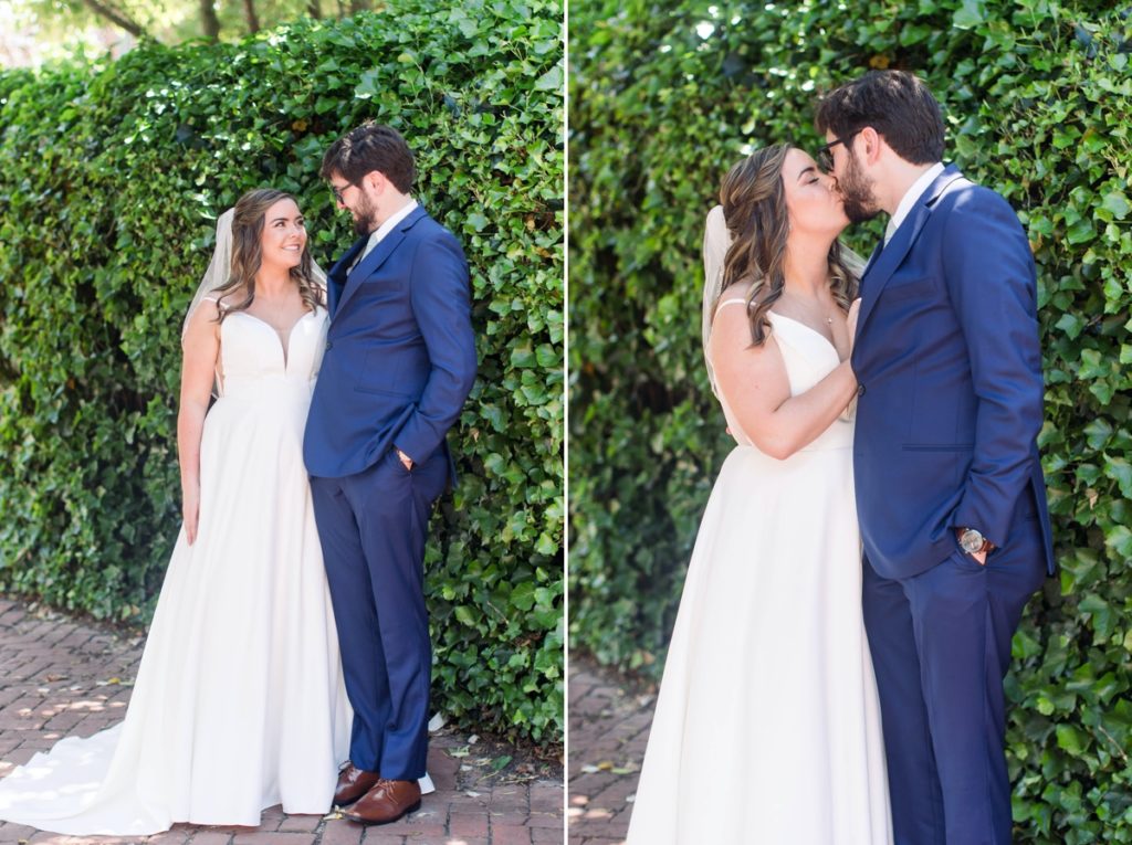 Seamus and Jessica side by side and kissing in front of a hedge, wedding photography done in Alexandria Virginia