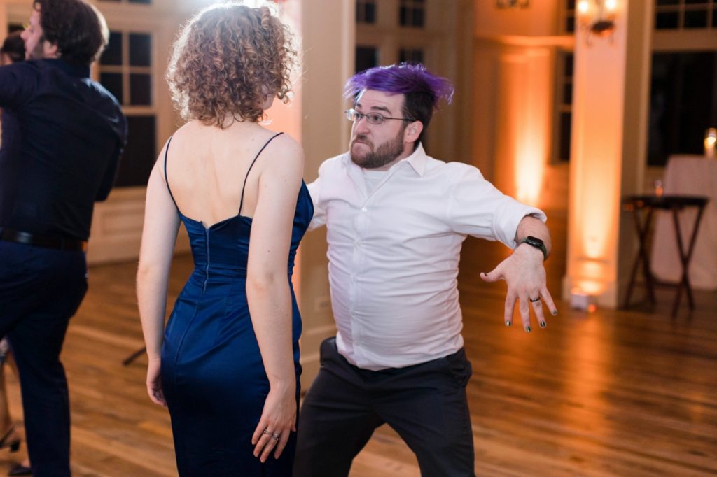 man in white button down shirt dancing with girl in blue spaghetti strap dress during the Cotoctin Hall Wedding reception at the Musket Ridge Golf Club in Maryland 