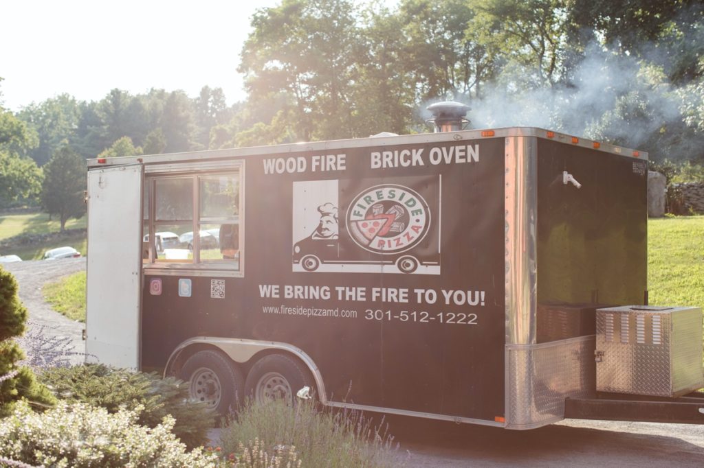 A pizza truck catering to the rehearsal dinner photography session.