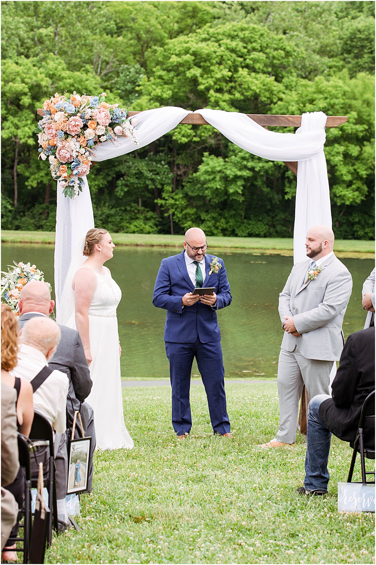 The bride and groom looking longingly at each other as they stand at the altar while their officiant starts their ceremony.