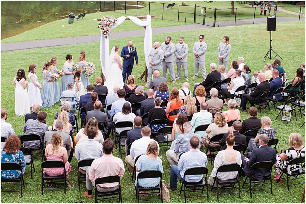 An overview look of Anneliese and Alec's wedding ceremony as their guests look on.