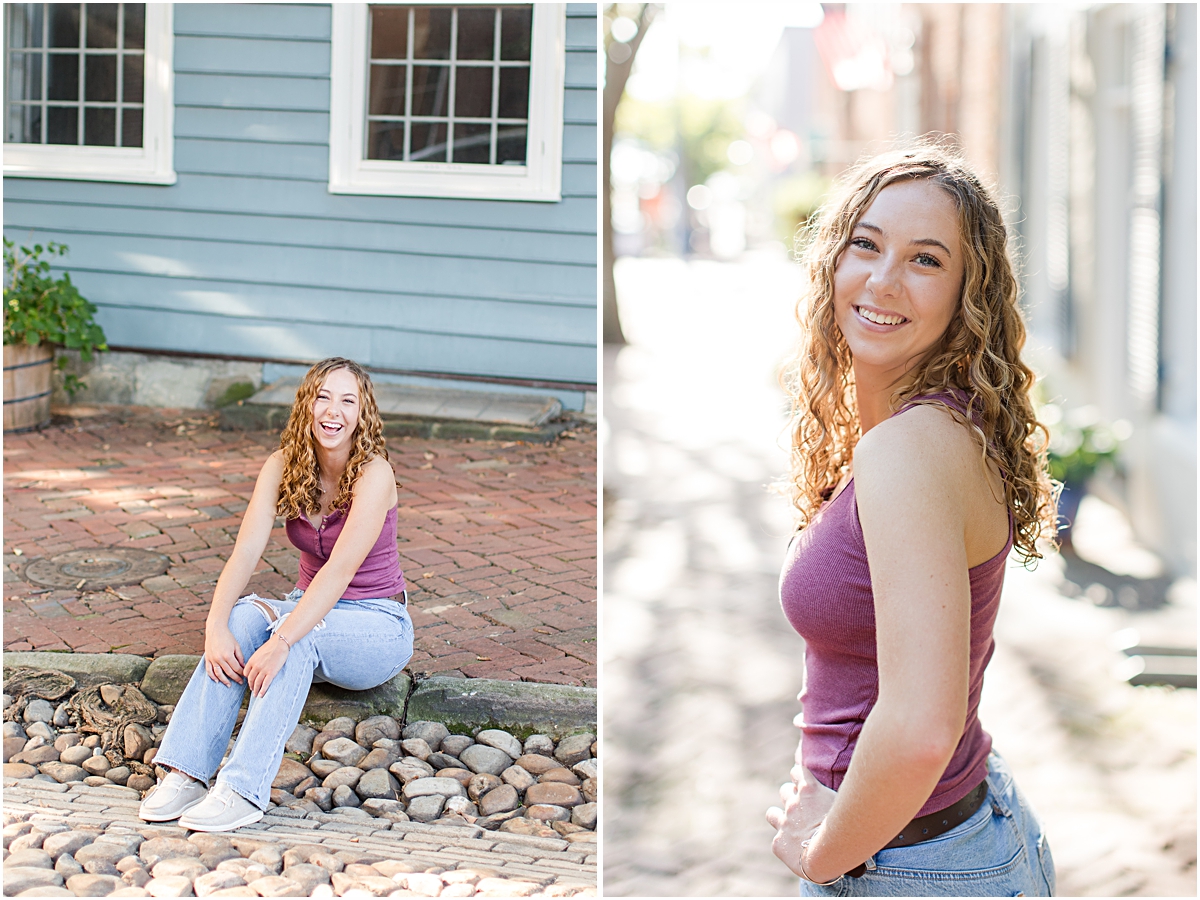 Amanda sitting on a curb in the city and smiling on a sidewalk; photo taken by a photographer in Virginia.