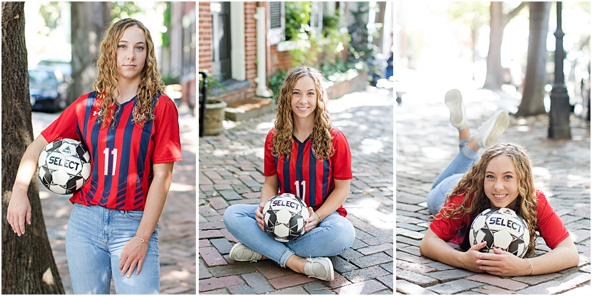 Amanda posing with a soccer ball while wearing a soccer jersey on the sidewalk